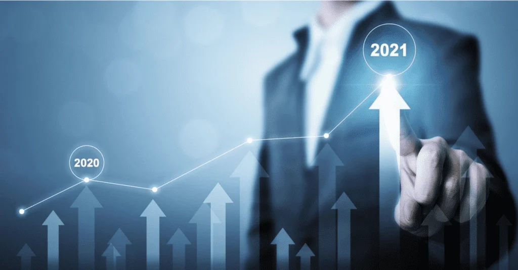 man touching line ascending line graph 2020 to 2021