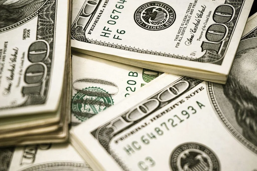 pile of 100 dollar bills