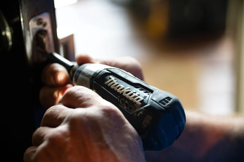 Contractor drilling into a wall with a makita drill