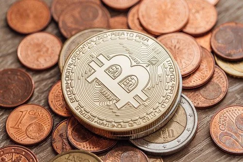 bitcoin coin on top of pennies