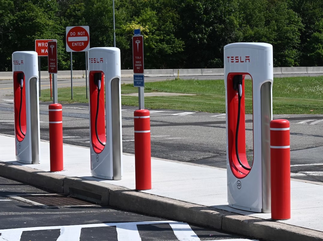 A row of Tesla electric car charging stations at a parking lot