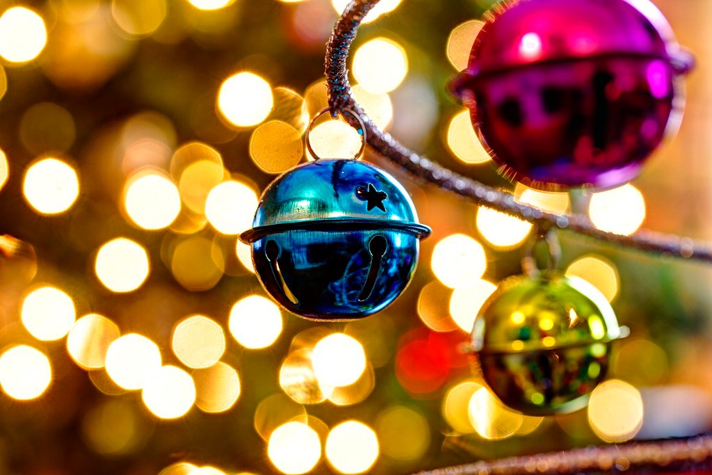 Up close photo of colorful bells on a Christmas tree