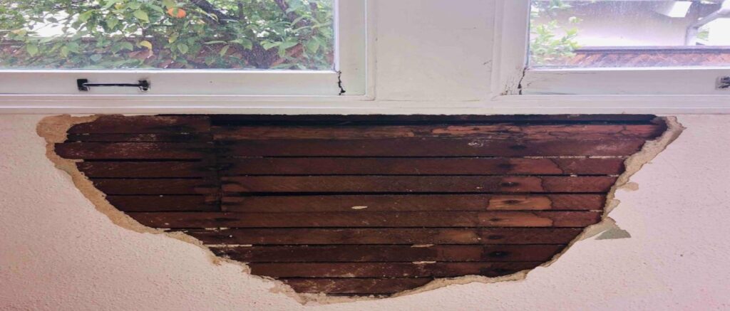 wood inside of the wall of a rental property needing repaired