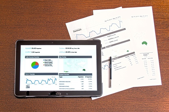 financial planning displayed on an ipad next to sheets of paper with financial information
