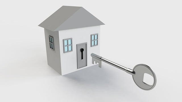 a large silver key unlocking the door of a tiny image of a house