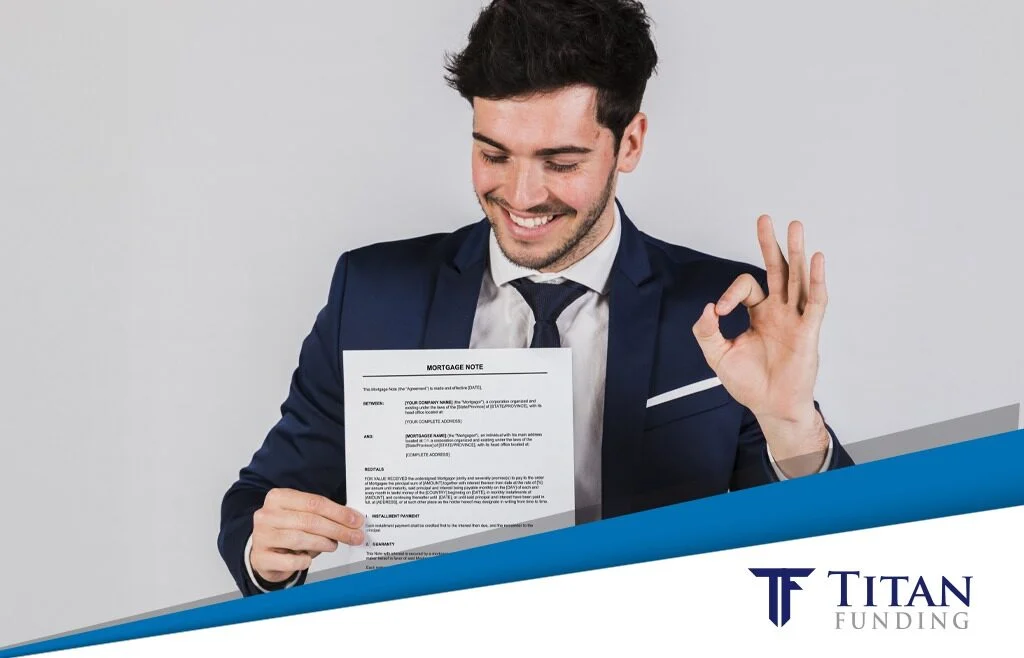 Man in suit holding up a financial document and making the ok sign with his other hand